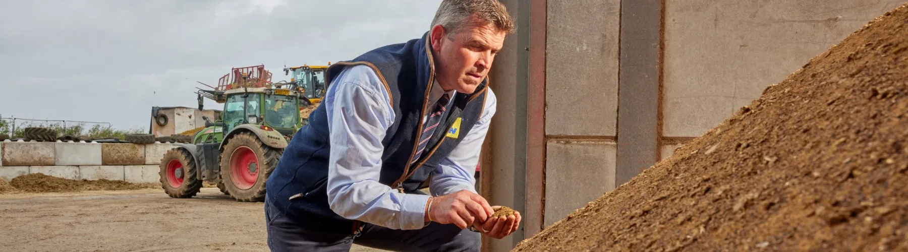 A colleague sampling feed at a customer farm in Somerset, UK