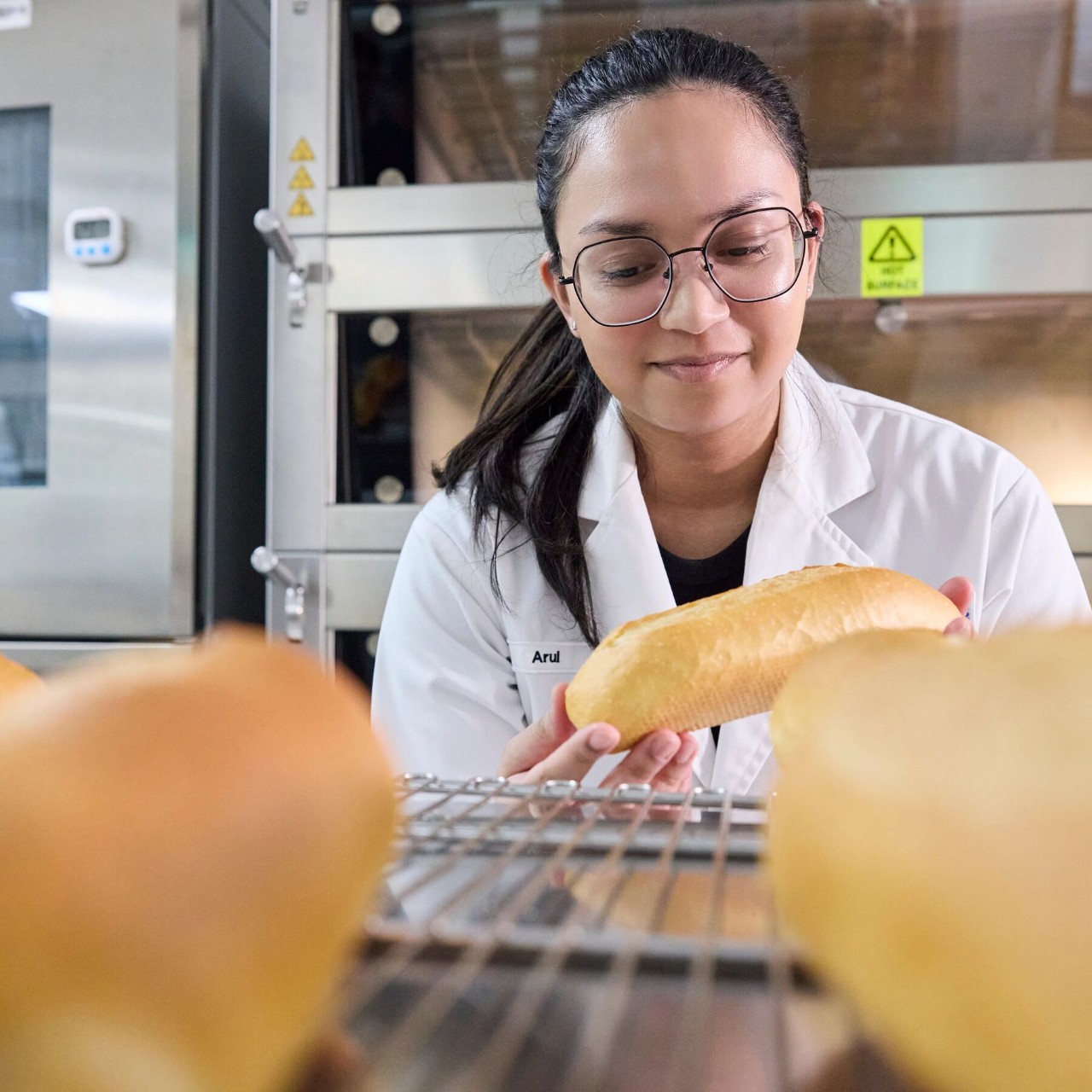  An application development technologist inspects bread rolls at the AB Enzymes baking lab, Singapore 