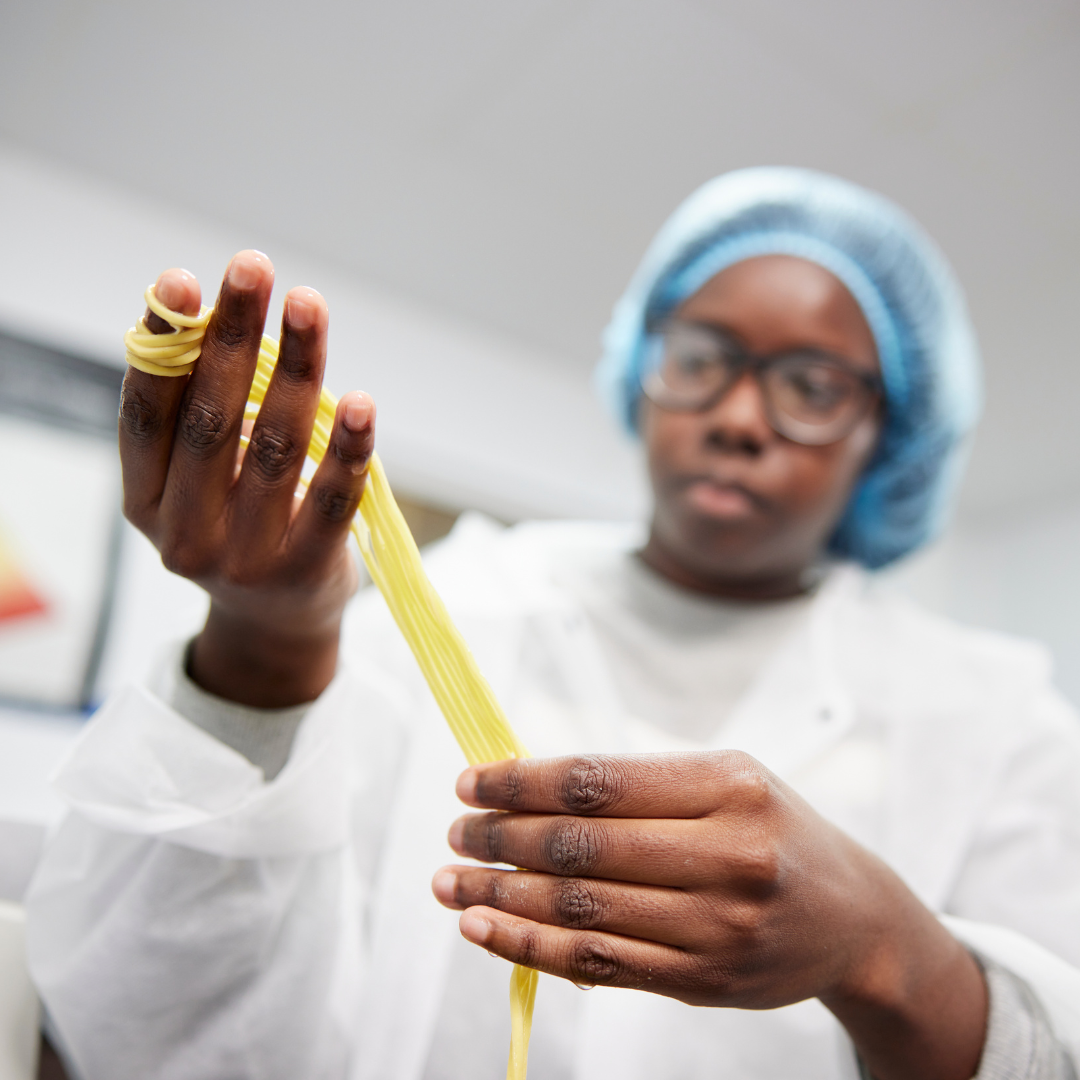 A colleague checks Westmill noodles for quality at our factory in Trafford, UK